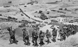 Troops marching at Omaha Beach
